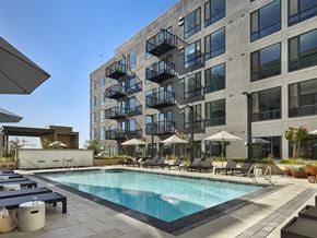 Santa Clara apartment for rent - A large building with a pool in front of it.