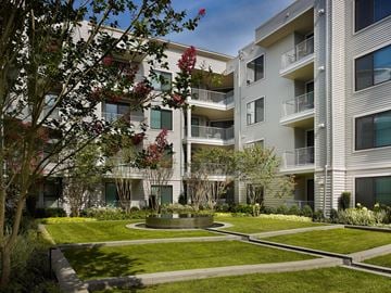 Union apartment for rent - A modern apartment complex with a well-manicured lawn and trees.