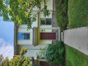 Coleman apartment for rent - A house with a red door and a window with a curtain.