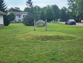 Coleman apartment for rent - A sign for Glen Arms Apartments stands in a grassy field.