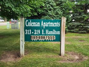 Coleman apartment for rent - A sign for Coleman Apartments with a phone number on it.