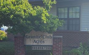 Midland apartment for rent - A sign for Granite Club Acres stands in front of a house.
