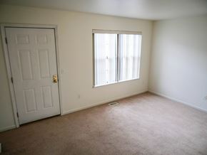 Midland townhouse for rent - A room with a white door and a window with white blinds.