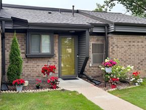 Farmington Hills townhouse for rent - A house with a grey roof and a green door.