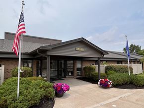 Farmington Hills townhouse for rent - The front of a building with a grey roof and a sign that reads "35150" is shown.