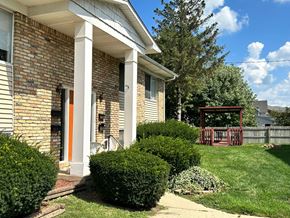 Durand apartment for rent - A house with a red door and a porch.
