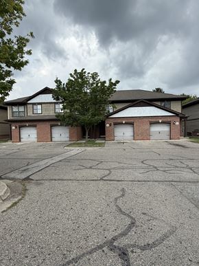 Flint townhouse for rent - A large, two-story house with a garage on the ground floor.