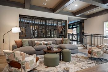 A living room with a couch and chairs and a wine cellar