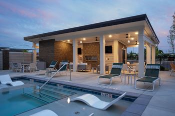 The pool and patio area of a house with a swimming pool