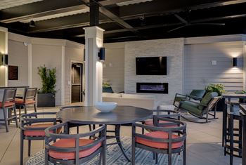 A living room with a table and chairs and a fireplace