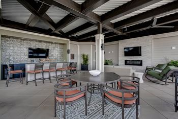 A dining area with a table and chairs and a fireplace