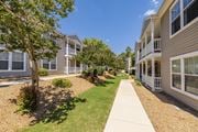 Augusta townhouse for rent - A sunny day at a residential complex with a clear blue sky.