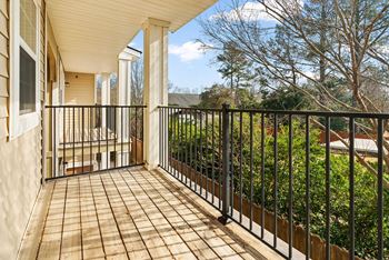 A balcony with a black railing and a tiled floor