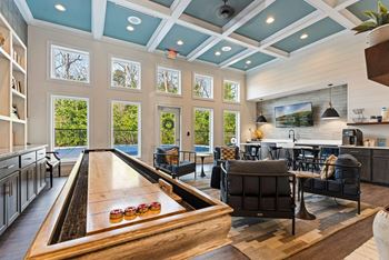 A billiard table is in the middle of a room with a pool table