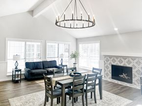 Glen Allen apartment for rent - A modern dining room with a fireplace and a large window.