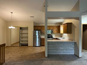 Waukesha apartment for rent - A kitchen with a refrigerator, sink, and cabinets.