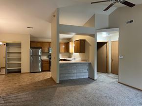 Waukesha apartment for rent - A kitchen area with a refrigerator, sink, and cabinets.