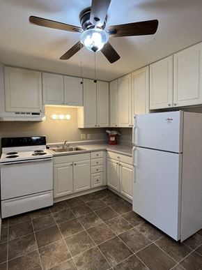 Milwaukee apartment for rent - a kitchen with white appliances and a ceiling fan