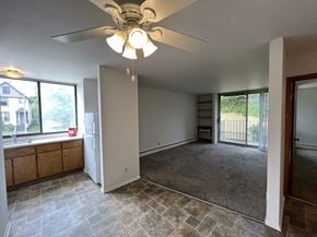 Milwaukee apartment for rent - an empty kitchen and living room with a ceiling fan
