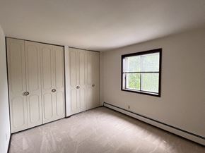 Milwaukee apartment for rent - an empty bedroom with white cabinets and a window