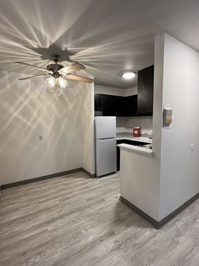 Milwaukee apartment for rent - a white kitchen with a ceiling fan and a white refrigerator