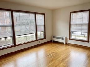 Milwaukee apartment for rent - the living room of a house with wood floors and large windows