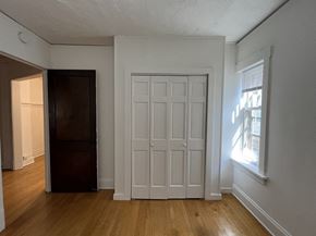 Milwaukee apartment for rent - the living room of an empty house with white walls and a door