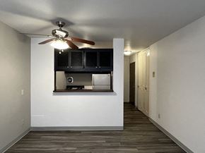 Milwaukee apartment for rent - A room with a ceiling fan and a cabinet with a microwave.