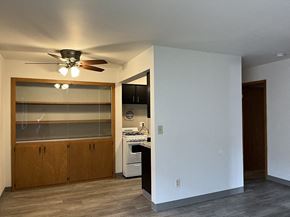 Milwaukee apartment for rent - A kitchen with a white wall and a ceiling fan.