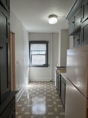 Milwaukee apartment for rent - A kitchen with a checkered floor and a window.