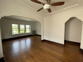 Milwaukee apartment for rent - an empty living room with a ceiling fan and hardwood floors