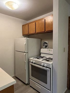 Milwaukee apartment for rent - A kitchen with a stove and refrigerator.
