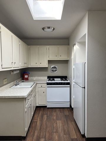 Milwaukee apartment for rent - A kitchen with white cabinets and a white fridge.
