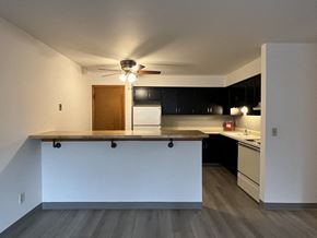 Hales Corners apartment for rent - an empty kitchen with a counter and a ceiling fan