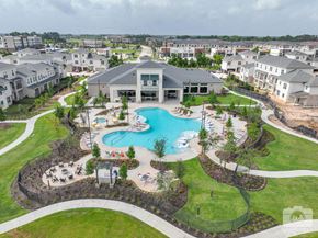 Spring apartment for rent - A large building with a pool in front of it.