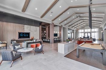 Large social room with billiard table, multiple flat panels televisions