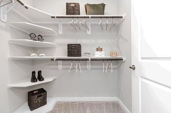 Large walk in closets with custom wood shelving