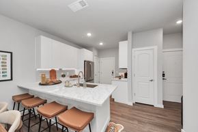 Spring apartment for rent - A kitchen with white cabinets and a granite countertop.