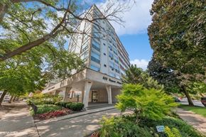 Evanston apartment for rent - a hotel building with trees and a sidewalk in front of it