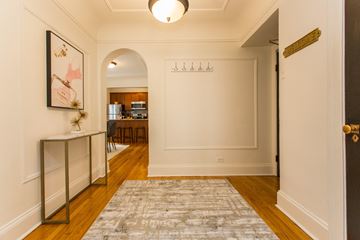 Chicago apartment for rent - a living room with a rug and a door to a kitchen