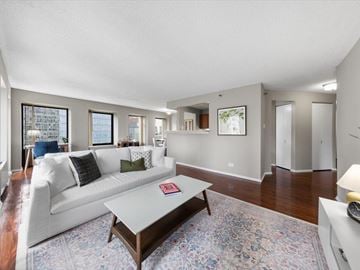 Chicago apartment for rent - A living room with a white couch and a coffee table.