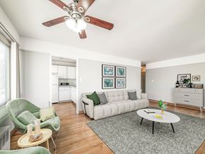 Chicago apartment for rent - a living room with a white couch and a green chair