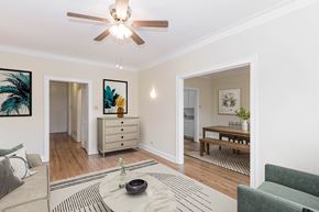 Chicago apartment for rent - a living room with a ceiling fan and a dining room in the background