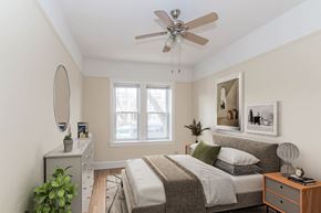 Chicago apartment for rent - a bedroom with a bed and a ceiling fan