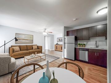 Chicago apartment for rent - a living room with a couch and a table and a kitchen with a refrigerator