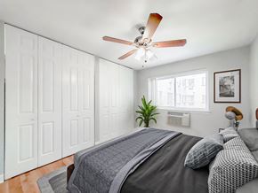 Chicago apartment for rent - a bedroom with a large bed and a ceiling fan
