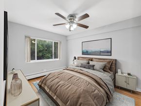 Chicago apartment for rent - a bedroom with a large bed and two windows