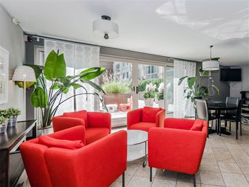 Chicago apartment for rent - a living room with red chairs and a table
