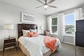 Des Peres apartment for rent - A bedroom with a large bed and a ceiling fan at Alinea Town and Country Luxury Apartments in Des Peres MO 63131..