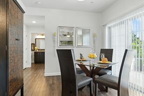 O'fallon apartment for rent - A dining room with a glass table and chairs at Bramblett Hills Luxury Apartments in O Fallon MO 63366